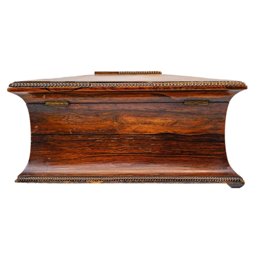 193 - A William IV rosewood tea caddy. Of swept sarcophagus form, with two internal compartments and a rec... 