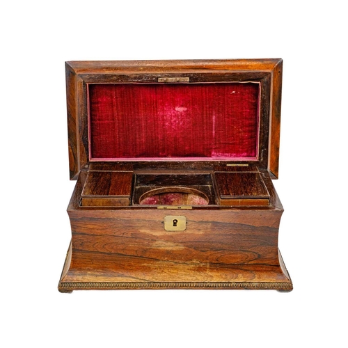 193 - A William IV rosewood tea caddy. Of swept sarcophagus form, with two internal compartments and a rec... 