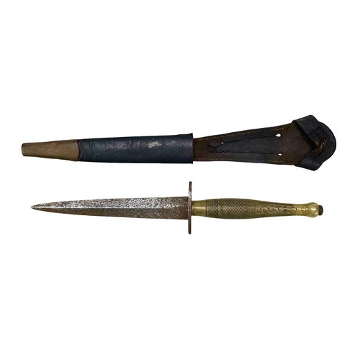 220 - An FS commando knife and scabbard, second pattern. With a chequered brass grip, and 14.7cm tapered b... 