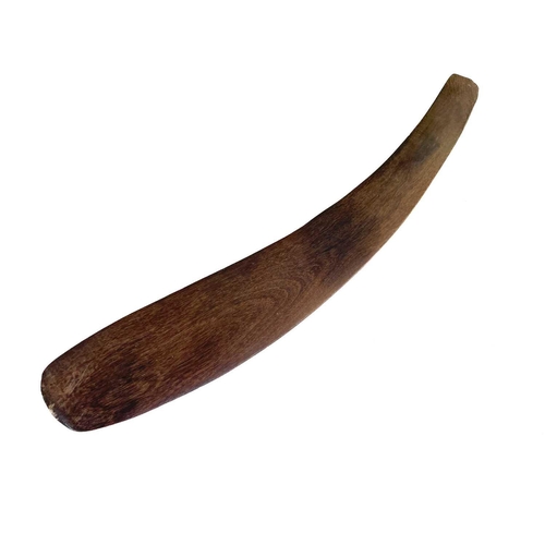 24 - A hardwood boomerang. One face with incised decoration, length 57cm.