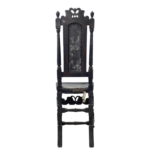 245 - A Charles II oak side chair. With carved cresting rail, turned uprights, and studded leather back an... 