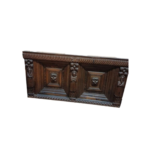 246 - An 18th century oak overmantle. Two panels with central lion masks within moulded borders flanked by... 