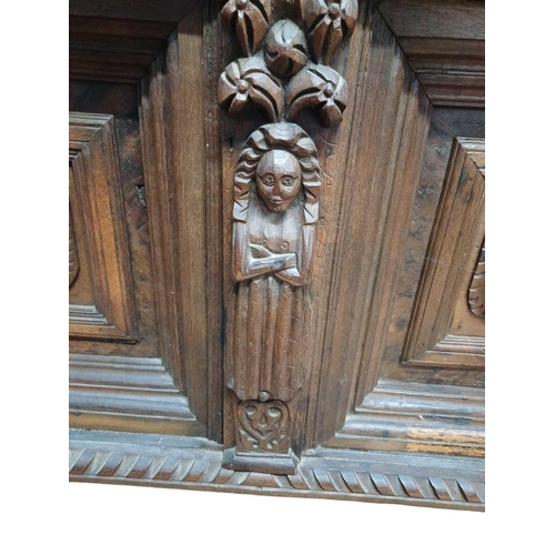 246 - An 18th century oak overmantle. Two panels with central lion masks within moulded borders flanked by... 