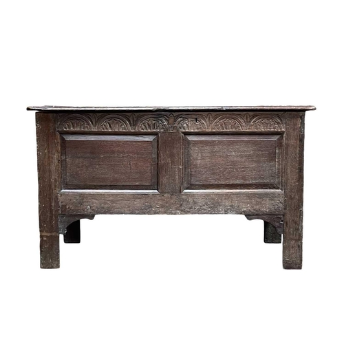 250 - An oak panel coffer. Early 18th century, with two fielded panels below an arcaded frieze, on stile f... 