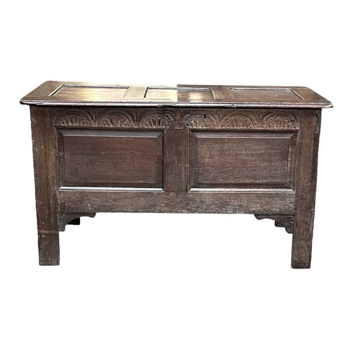 250 - An oak panel coffer. Early 18th century, with two fielded panels below an arcaded frieze, on stile f... 