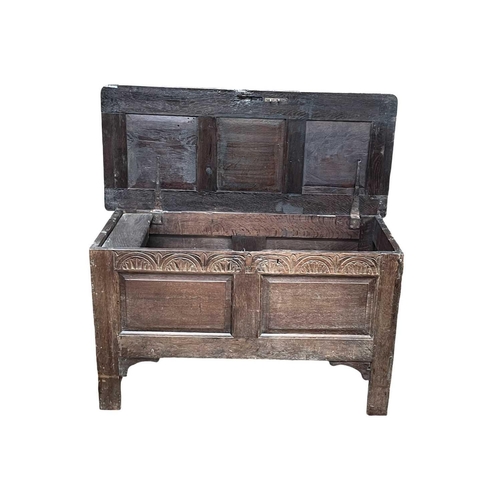 250 - An oak panel coffer. Early 18th century, with two fielded panels below an arcaded frieze, on stile f... 