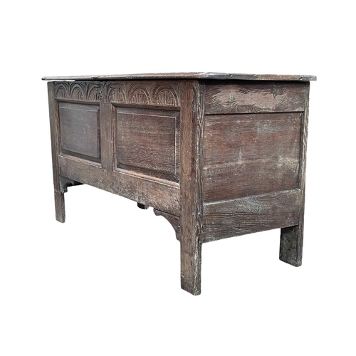 250 - An oak panel coffer. Early 18th century, with two fielded panels below an arcaded frieze, on stile f... 