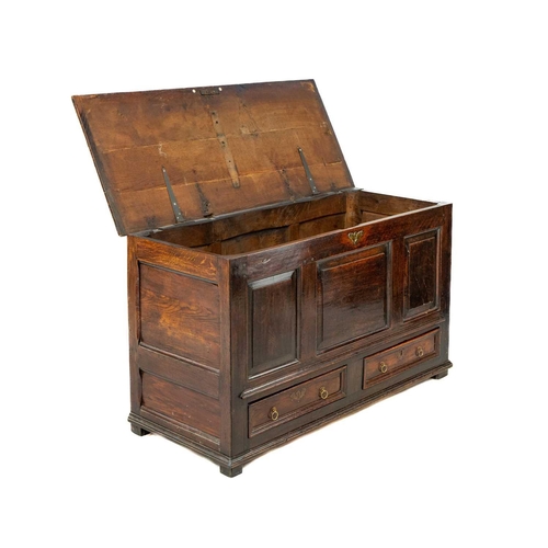 252 - A George III oak mule chest. The front with three fielded panels above two drawers, height 72cm, wid... 