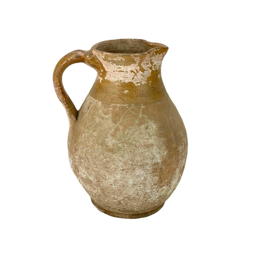 255 - A pottery jug. Possibly Welsh, 18th/early 19th century, height 29.5cm, together with a large earthen... 