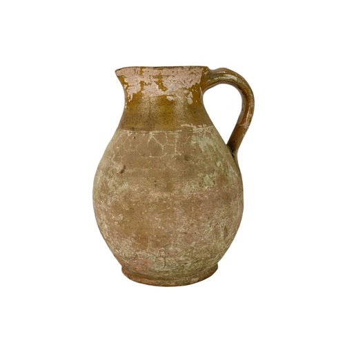 255 - A pottery jug. Possibly Welsh, 18th/early 19th century, height 29.5cm, together with a large earthen... 