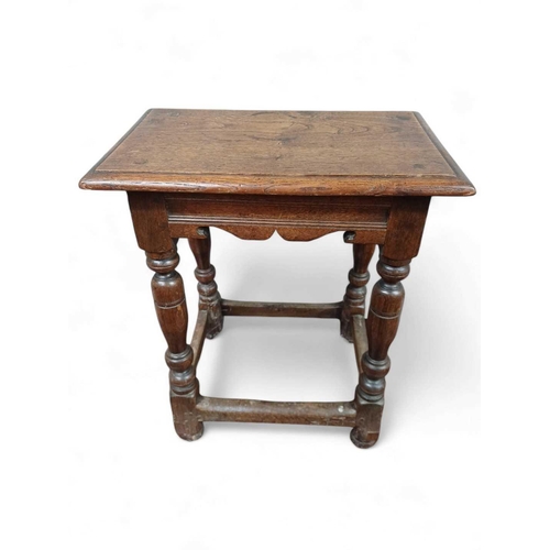 257 - An oak joint stool. 17th century and later, with a shaped and moulded frieze, on turned legs, with s... 