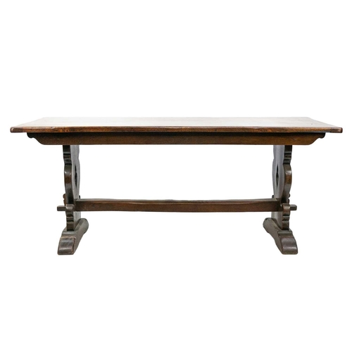 258 - A 19th Century oak refectory table. Raised on twin trestle supports and chamfered square stretcher w... 