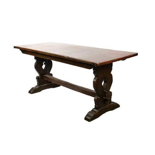 258 - A 19th Century oak refectory table. Raised on twin trestle supports and chamfered square stretcher w... 