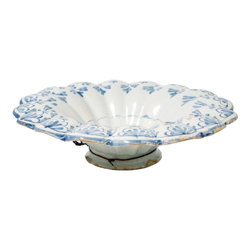 261 - A probably South German faience blue and white lobed dish. Decorated in Chinoiserie style, diameter ... 