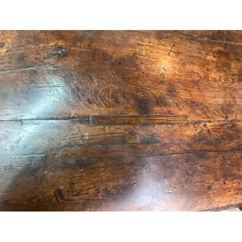 263 - A 17th century oak dining table. With cleated planked top, the turned legs joined with H stretchers ... 