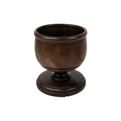 265 - An 18th century turned treen pedestal wassil cup. Height 12cm diameter 11cm.