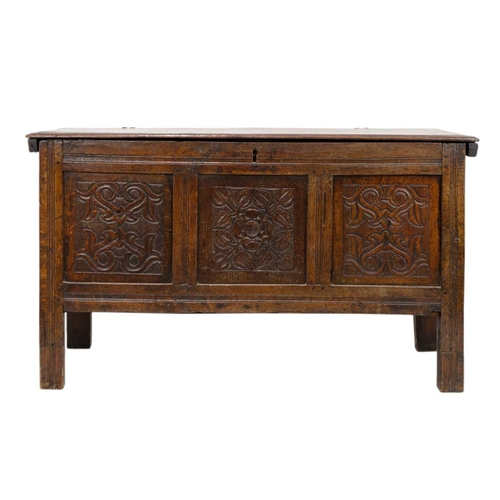 266 - An oak panel coffer. 18th century, with triple carved panel front, on stile feet, height 69cm, width... 