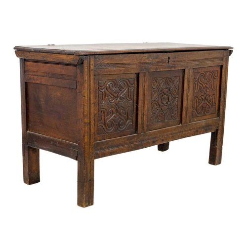 266 - An oak panel coffer. 18th century, with triple carved panel front, on stile feet, height 69cm, width... 