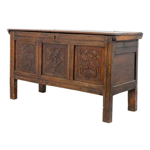 266 - An oak panel coffer. 18th century, with triple carved panel front, on stile feet, height 69cm, width... 