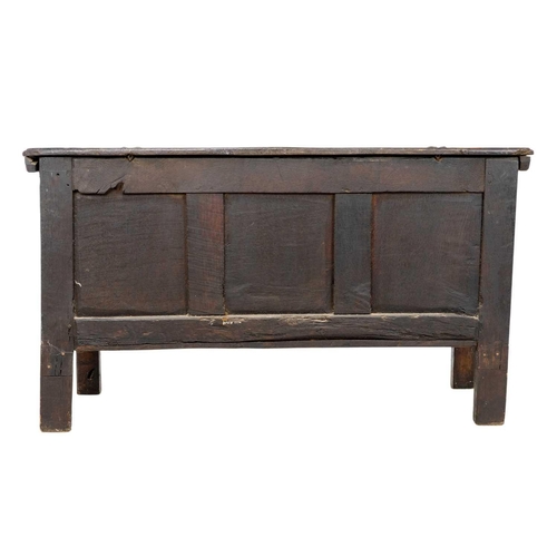 266 - An oak panel coffer. 18th century, with triple carved panel front, on stile feet, height 69cm, width... 