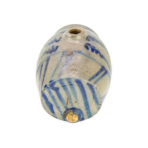 272 - An unusual saltglazed Westerawld type spirit flask. With applied feet and simple blue painted decora... 