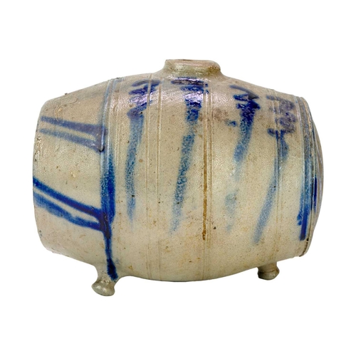 272 - An unusual saltglazed Westerawld type spirit flask. With applied feet and simple blue painted decora... 