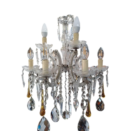 289 - A six branch cut glass chandelier. With C scroll arms trailing drops terminating with lustres, amber... 