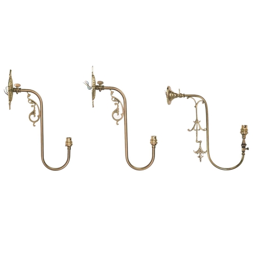 303 - A pair of brass swan neck wall lights. Height 43cm, and another similar (3).