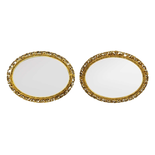 316 - A pair of gesso gilt frame mirrors. With pierced Florentine style outer border, 67cm x 84cm. (2)