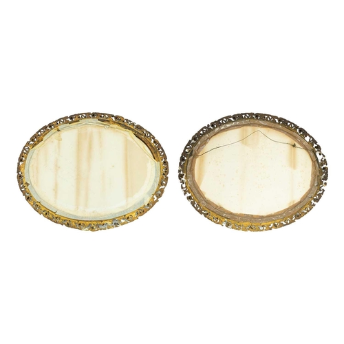 316 - A pair of gesso gilt frame mirrors. With pierced Florentine style outer border, 67cm x 84cm. (2)