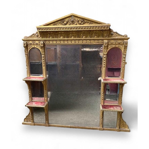 317 - A Victorian gilt overmantle With bevelled plates and velvet-lined shelves beneath an architectural p... 