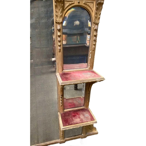 317 - A Victorian gilt overmantle With bevelled plates and velvet-lined shelves beneath an architectural p... 