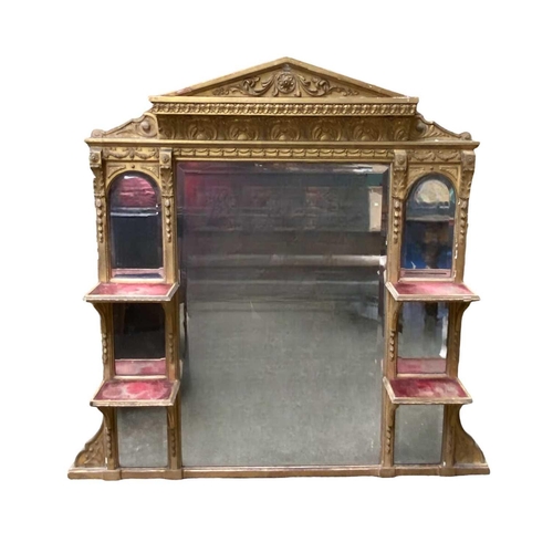 317 - A Victorian gilt overmantle With bevelled plates and velvet-lined shelves beneath an architectural p... 