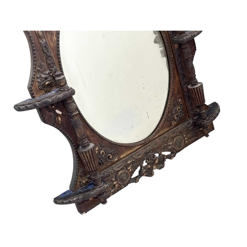 320 - A Victorian gilt gesso wall mirror. With an oval plate flanked by fluted columns and with neo-classi... 