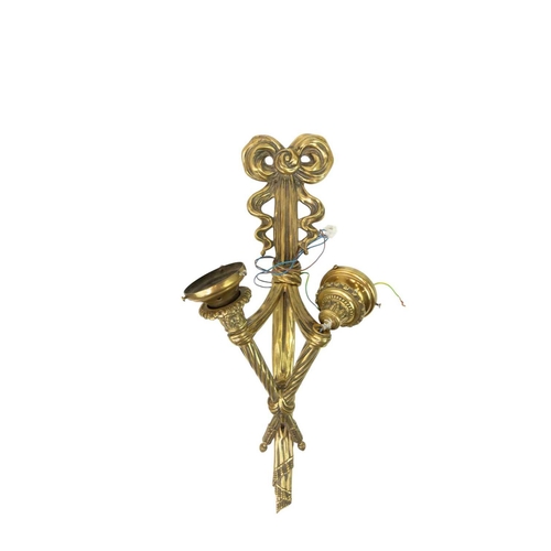 323 - A large late 19th/20th century French brass wall applique. With twin scones issuing from a ribbon an... 