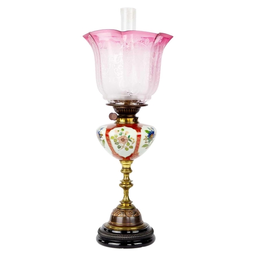 325 - A late Victorian oil lamp with large cranberry etched shade. Stamped Young's, height 63.5cm. A