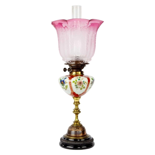 325 - A late Victorian oil lamp with large cranberry etched shade. Stamped Young's, height 63.5cm. A