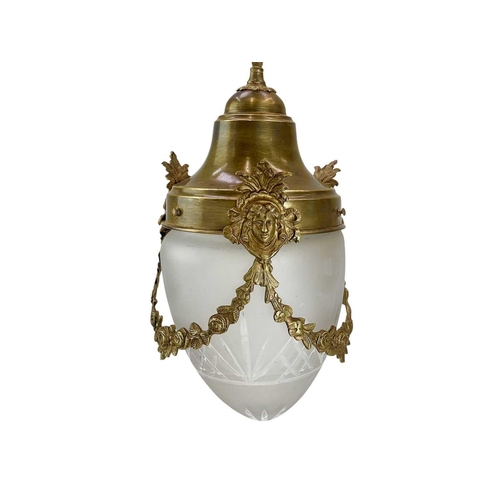 326 - An early 20th century French brass lantern. With floral swags and mask decoration etched frosted gla... 