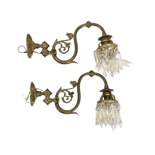 338 - A pair of cast brass wall lights. With crystal drops, height 21cm, depth 30cm (2).