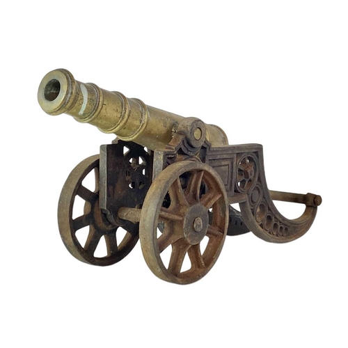 4 - A brass and iron model cannon. Height 21cm length 46cm.