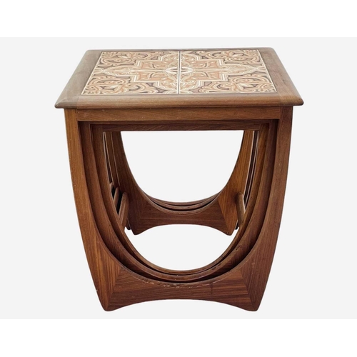 417 - A nest of three G Plan teak occasional tables. The larger table with a tiled top, height 51cm, width... 