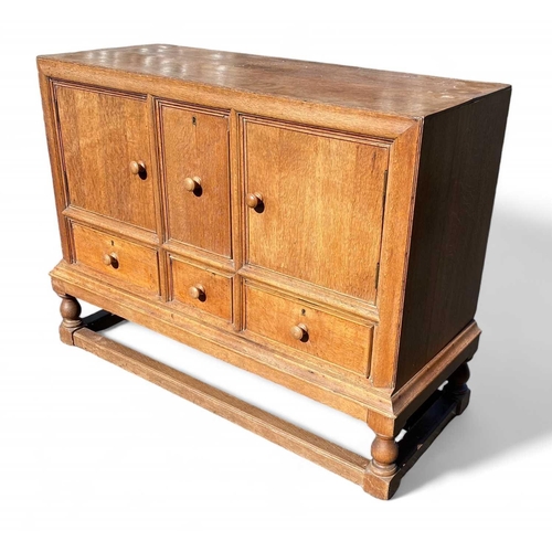 418 - A Heals light oak sideboard. Fitted two doors flanking a deep cellarette drawer, with three further ... 