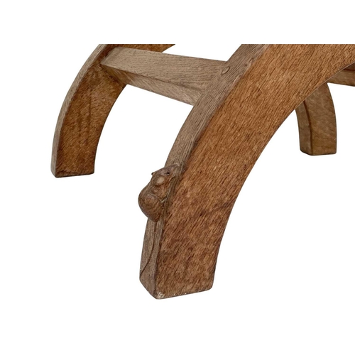 420 - A Robert Thompson 'Mouseman' oak X-frame stool. With a slung leather seat and curved supports, carve... 