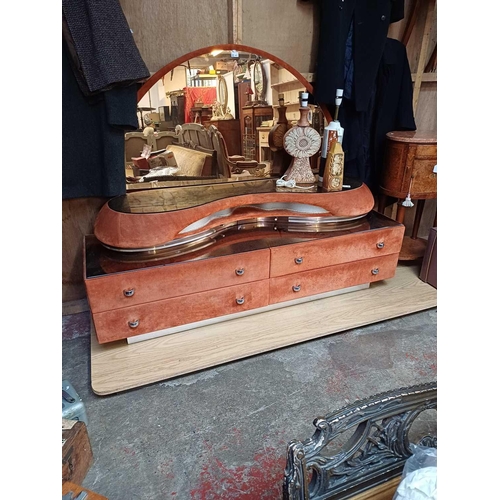 423 - An Italian Verardo faux suede dressing table. Circa 1980, with a swept rose tinted mirror above four... 