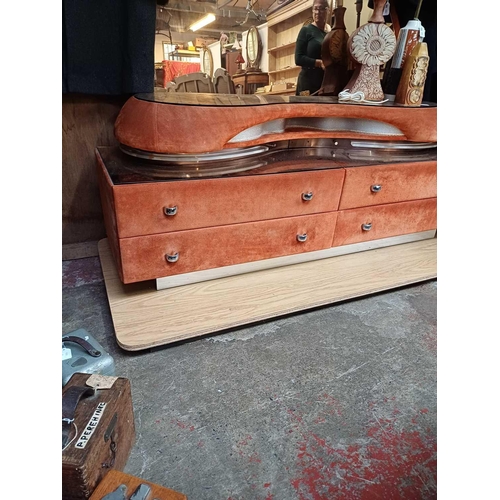 423 - An Italian Verardo faux suede dressing table. Circa 1980, with a swept rose tinted mirror above four... 