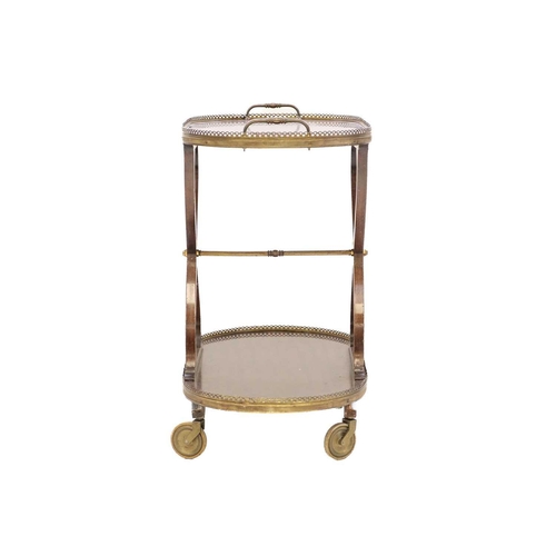 428 - A French mid-century figured mahogany two tier cocktail trolley or cart. With pierced brass gallerie... 