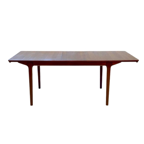 430 - A mid-century McIntosh teak extending dining table and ten chairs. The table with two additional fol... 