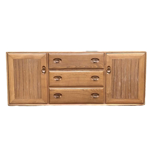 431 - An Ercol light elm Windsor sideboard. Fitted with three central drawers and two cupboards, height 62... 