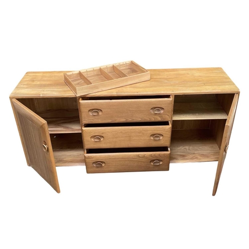 431 - An Ercol light elm Windsor sideboard. Fitted with three central drawers and two cupboards, height 62... 