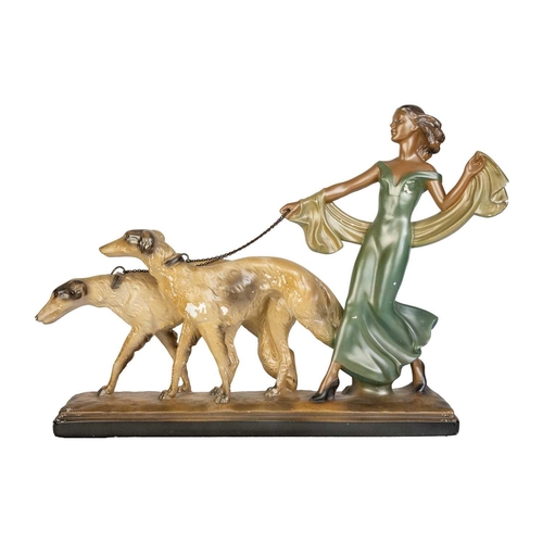 438 - An Art Deco spelter figure of a kneeling lady and greyhound. On a marble base, with an attahed plaqu... 